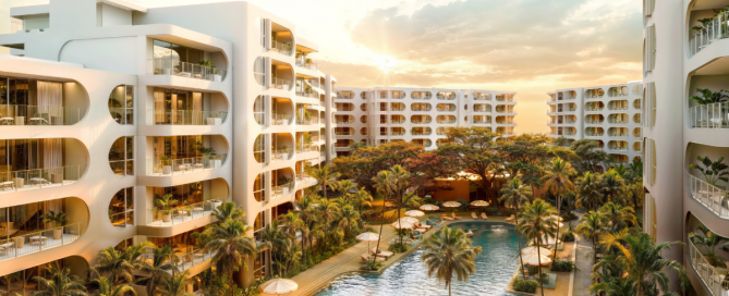 Exterior view of the standard residences in Phuket, modern low-rise building with clean architectural lines, surrounded by tropical landscaping and clear blue skies.