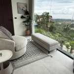 3-bedroom sea view pool villa near Layan Beach, Phuket armchair and footstool beside a floor to ceiling picture window with sea view PSV-LAY-632