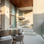 3-4 bedroom condos and penthouses near Layan Beach, Phuket living area with access to terrace with jacuzzi pool and dining table PSC-LAY-1038