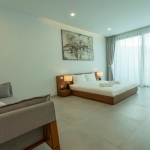3–4 bedroom pool villa with large pool in Rawai, Phuket master bedroom with sofa PSV-RAW-1099