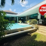 2-bedroom pool villa in Soi Samakki, Rawai, Phuket exterior shot showing pool and garden with price reduced stamp PSV-RAW-1422