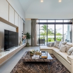 3-bedroom pool villa for sale in Pru Jampa near UWC Phuket white couch and tv PSV-PRJ-1429