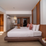 6+1 bedroom villa in Pasak, Cherng Talay, Phuket bedroom with built-in wood furniture, dressing table and pink throw pillows on bed PSV-CHE-1419