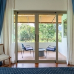 4-bedroom pool villas in Baan Manik, Phuket balcony with 2 blue chairs and coffee table PSV-MNK-1267