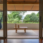 4-bedroom pool villas in Baan Manik, Phuket balcony with 2 blue hammocks and coffee table PSV-MNK-1267