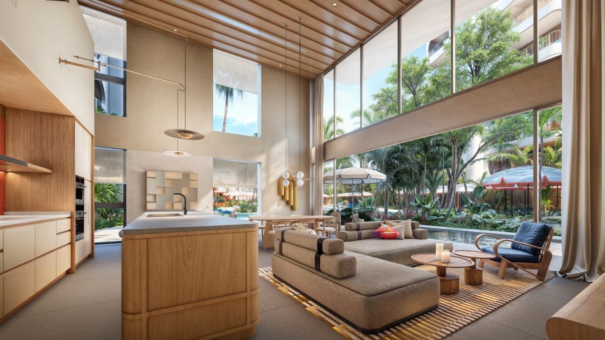 Stylish duplex unit at The Standard Residences Phuket featuring double-height ceilings, modern interiors, open-plan living space, and expansive windows with tropical views near Bang Tao Beach.