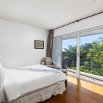 4-bedroom hillside sea view pool villa Surin Beach, Phuket bedroom with large sliding glass doors and balcony PSV-SUR-800