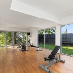 4-bedroom hillside sea view pool villa Surin Beach, Phuket gym with floor to ceiling glass walls and doors and garden view PSV-SUR-800