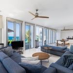 4-bedroom hillside sea view pool villa Surin Beach, Phuket open plan living and dining area with glass doors to pool terrace PSV-SUR-800