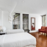 4-bedroom hillside sea view pool villa Surin Beach, Phuket bedroom with twin bed and red armchair PSV-SUR-800