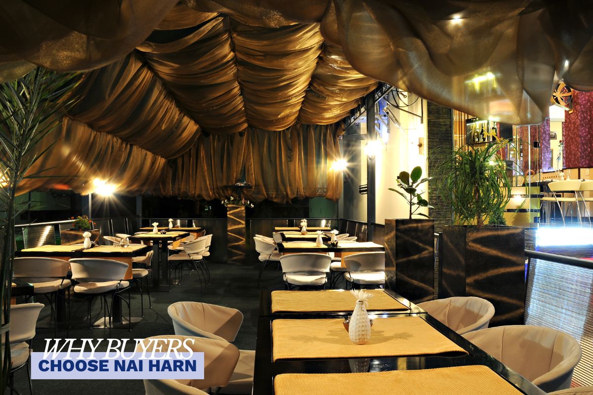 Upscale restaurant in Nai Harn, Phuket, featuring elegant open-air dining with tropical greenery — reflecting the relaxed yet refined lifestyle that attracts property buyers to Nai Harn.