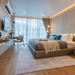 1–2 bedroom condos for sale near Kata Beach, Phuket bedroom with working table, tv and floor to ceiling sliding glass doors PSC-KAT-1547