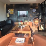 3-bedroom sea view condo near CoCo Pier in Panwa, Phuket living room with black granite wall behind tv PSC-PAN-1550