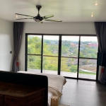 3 villas and 1 apartment hillside estate in Nai Harn, Phuket bedroom wtih balcony overlooking rooftops PSV-NAH-1542