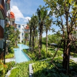 1-2 bedroom condos & penthouses in the Laguna Area, Phuket exterior view of development and newly planted trees beside pool PSC-CHE-1560