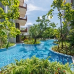 1-2 bedroom condos & penthouses in the Laguna Area, Phuket shared pool surrounded by tropical plants PSC-CHE-1560