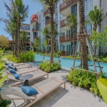 1-2 bedroom condos & penthouses in the Laguna Area, Phuket sun loungers beside pool PSC-CHE-1560