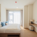 1-2 bedroom condos & penthouses in the Laguna Area, Phuket bedroom with baby blue throw pillows PSC-CHE-1560