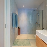 1-3 bedroom condos near Bang Tao Beach, Phuket bathroom and shower with light blue towel PSC-BAN-1559