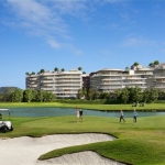 2–3 bedroom condos & penthouses in Laguna, Phuket golfers near sand trap with the development in the background PSC-LAG-1566