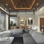 3-4 bedroom pool villas near Pa Lai Beach in Chalong, Phuket living area with L-shaped gray couch PSV-CHA-1570