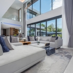 5-bedroom pool villa near Nai Harn Beach in Rawai, Phuket living area with double height ceilings and glass walls PSV-NAH-1577