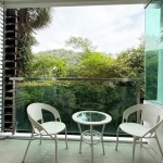 1-bedroom condo for sale 400m to Kalim Beach, Phuket terrace with 2 wrought iron seats and a small glass table PSC-KAL-1591