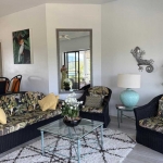 2-bedroom condo in Laguna Phuket living area with black wicker seats and tropical patterned upholstery PSC-LAG-1598