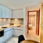 2-bedroom condo near Laguna Beach in Bang Tao, Phuket kitchen with white cabinets and small round table PSC-BAN-1595