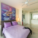 2-bedroom condo near Surin and Bang Tao Beach all white bedroom with purple bedding and lotus flower painting PSC-SUR-1606