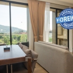 2-bedroom condo near Bang Tao Beach, Phuket living and dining area with mountain views PSC-BAN-1597