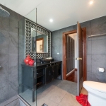 2-bedroom duplex condo in Laguna, Phuket bathroom with gray tiles and red accents PSC-LAG-1594