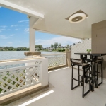 2-bedroom duplex condo in Laguna, Phuket covered terrace with 2 seater dining table overlooking the lake PSC-LAG-1594