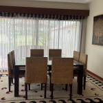 3-bedroom pool villa directly beside the fairways in Laguna, Phuket indoor dining with glass walls and sheer white curtains PSV-LAG-1580