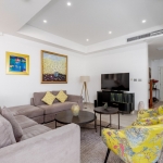 3-bedroom pool villa for sale in Laguna, Phuket living area with gray couch and yellow armchairs PSV-LAG-1579