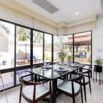 3-bedroom pool villa for sale in Laguna, Phuket dining area with glass walls beside pool PSV-LAG-1579