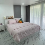 3-bedroom condo in Kamala, Phuket bedroom with baby pink bed cover and sheer white curtains PSC-KAM-1604