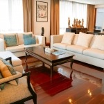 3-bedroom marina penthouse in Koh Kaew, Phuket living room with white couch and mahogany wooden floors PSC-KOH-1609
