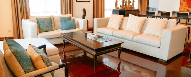 3-bedroom marina penthouse in Koh Kaew, Phuket living room with white couch and mahogany wooden floors PSC-KOH-1609