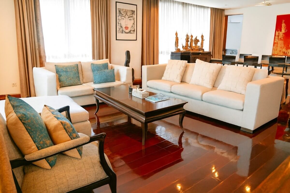 3-bedroom marina penthouse in Koh Kaew, Phuket living room with white couch and mahogany wooden floors PSC-KOH-1609