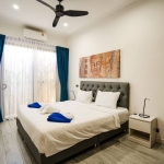 4-bedroom pool villa in Soi Samakki, Rawai Phuket bedroom with dark gray upholstered bed PSV-RAW-1583