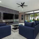 4-bedroom pool villa near Rawai & Nai Harn Beaches in Phuket pool living room with blue couch and tv PSV-RAW-1602