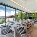 5-bedroom pool villa for sale near Kamala Beach, Phuket dining and living area with floor to ceiling glass walls PSV-KAM-1587